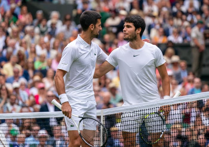 Novak Djokovic and Carlos Alcaraz put an arm around each other over the net after the finals at Wimbledon